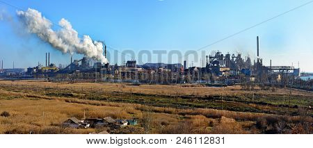 Smoke From The Industrial Plant Over The City In The Clouds. Factory Smoke Tubes. Polluted Air