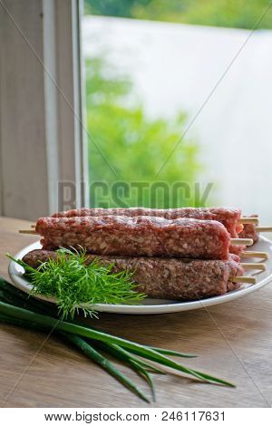 Raw Lulya Kebab From Meat On A White Plate.