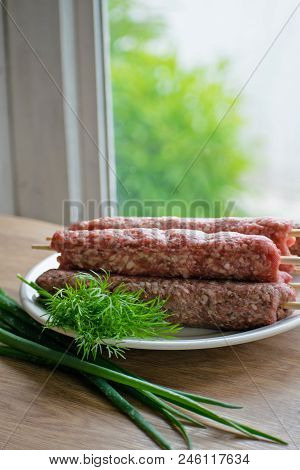 Raw Lulya Kebab From Meat On A White Plate.