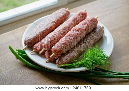 Raw Lulya Kebab From Meat On A White Plate.