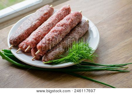 Raw Lulya Kebab From Meat On A White Plate.