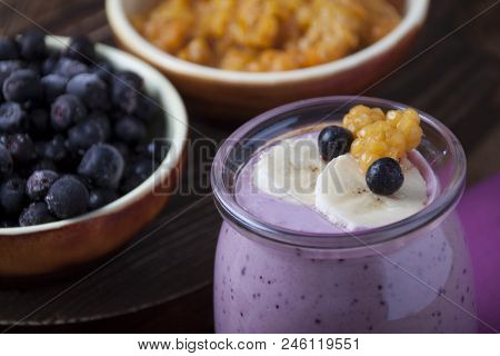 Smoothies Of Cloudberries, A Banana And A Blueberry On A Lilac Napkin And Blueberries And Cloudberri