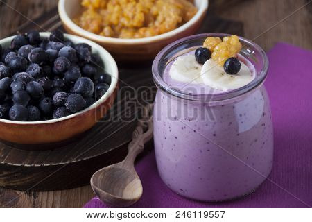 Smoothies Of Cloudberries, A Banana And A Blueberry On A Lilac Napkin And Blueberries And Cloudberri