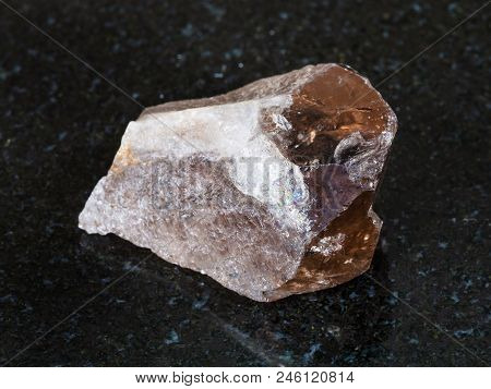 Macro Shooting Of Natural Mineral - Raw Smoky Quartz Crystal On Black Granite From Ural Mountains