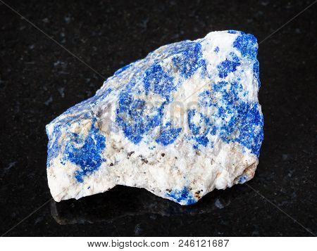 Macro Shooting Of Natural Mineral - Raw Lazurite (lapis Lazuli) Stone On Black Granite From Ural Mou