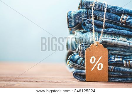 Sale, Discount, Black Friday Concept With Tag , Blue Jeans On A Light Background. Copyspace.