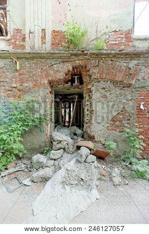 Demolition Of An Abandoned Residential Stone Two-story House On Sovetskaya Street 2a. A Surviving Wa