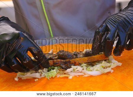 Fast Food Vegan Roll Wrap Cooking Process With Gloved Hands And Vegetables Ingradients Close Up Phot