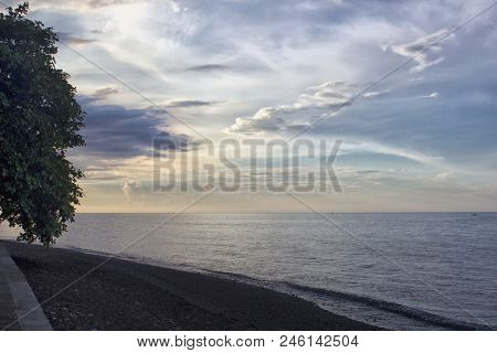 Sunset On Tropical Black Sand Beach. Bali