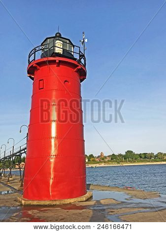Red Lighthouse, At The Entrance Of The Black River On Lake Michigan Leading To The Harbor In South H