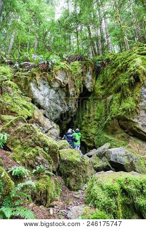 Qualicum Beach, Canada - July 7, 2016: A Group Of Visitors Enter A Cave Opening At Horne Lake Caves 