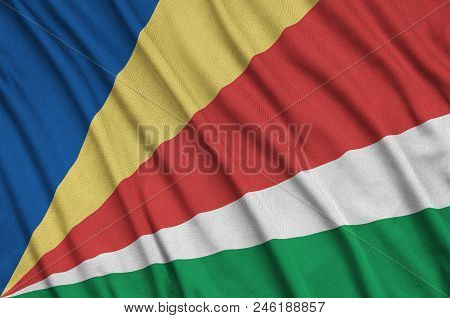 Seychelles Flag  Is Depicted On A Sports Cloth Fabric With Many Folds. Sport Team Waving Banner
