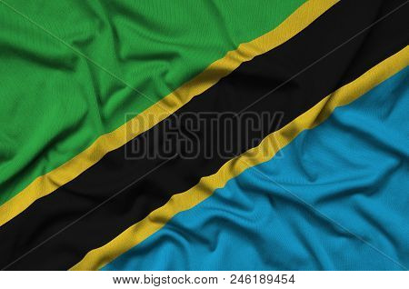 Tanzania Flag  Is Depicted On A Sports Cloth Fabric With Many Folds. Sport Team Waving Banner