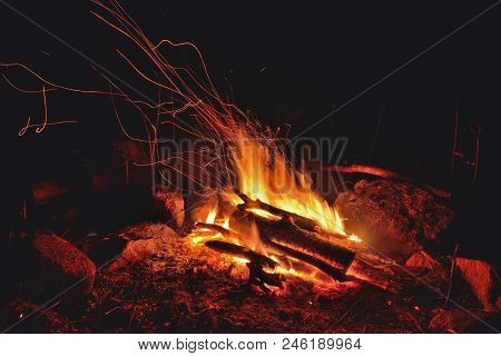 A Close Up Of The Aflame Bonfire With Sparks.