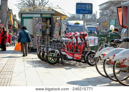 Beijing, China - March 14, 2016: People Are Walking And Driving Through The Streets With Bicycles, S