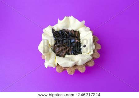 Cake Basket Of Short Pastry Cream And Chocolate Close-up On Purple Background