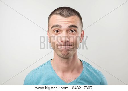 European Man Modest And Embarrassed, Isolated On Gray Background. He Is Shy And Looking In Camera Wi