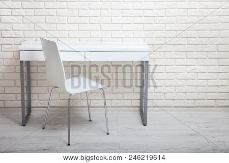 White Table Near The White Wall. Empty Workplace In The Room. White Background Mock Up.