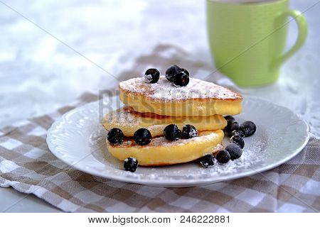 Pancakes With Corn Flour, Sprinkled With Powdered Sugar And Berries