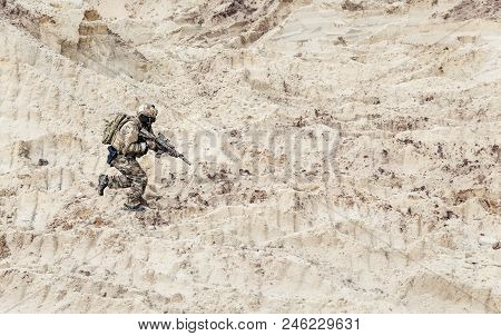 Army Soldier Or Commando With Assault Rifle In Ocp Camouflage Combat Uniform, Wearing Helmet And Wit