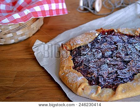 Open Pie-gallets From Fresh Dough With Plums And Cinnamon. Sprinkled With Powdered Sugar. Rustic Sty