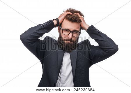 Bearded Male In Official Wear And Glasses Putting Hands On Head In Disapointment Stading In Studio W