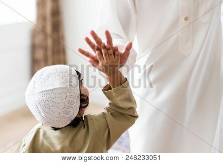 Muslim boy giving a high five