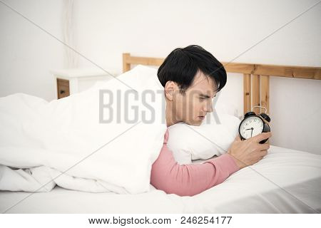 Man Wake Up Doing Turn Off Alarm Clock In The Morning. He Tired And Lazy To Work.