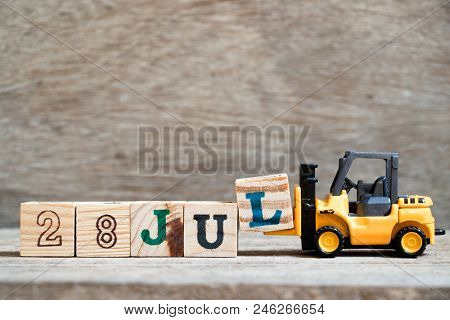 Toy Forklift Hold Block L To Complete Word 28 Jul On Wood Background (concept For Calendar Date In M
