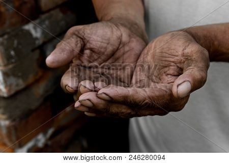 The Poor Old Man's Hands Beg You For Help. The Concept Of Hunger Or Poverty. Selective Focus. Povert