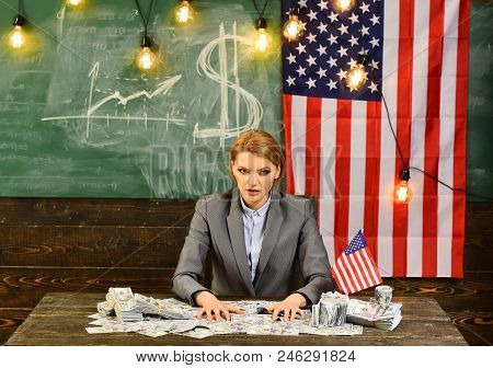 Economy And Finance. Economy Of America With Woman Holding Money At Flag