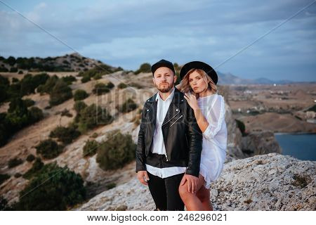 Romantic Summer Love Story On A Sunset In Mountains. Young Girl And Boy In Love.
