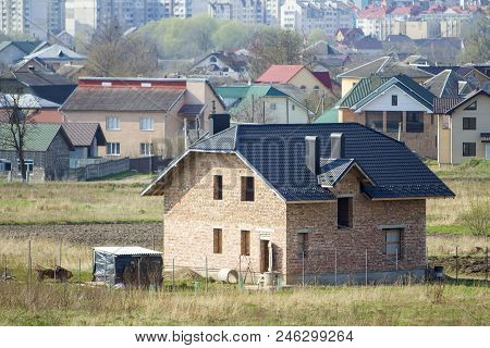 Brand New Spacious Brick Two Story Residential House With Tiling Roof And Windows Openings In Suburb