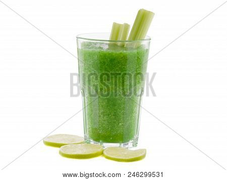 A Glass Of Green Smoothies Made Of Lemons And Lettuce Is Situated On The White Background.