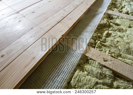 Installation Of New Floor Of Wooden Natural Planks And Mineral Wool Insulation For Isolation And Kee