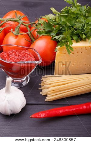 There Are Fragrant Tomatoes Parsley Chese Ketchup Garlic Hot Chili Peppers And Dry Pasta Situated On