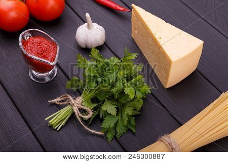 Tasty And Appetizing Tomatoes Parsley Chese Ketchup Garlic Hot Chili Peppers And Dry Pasta Are Ready