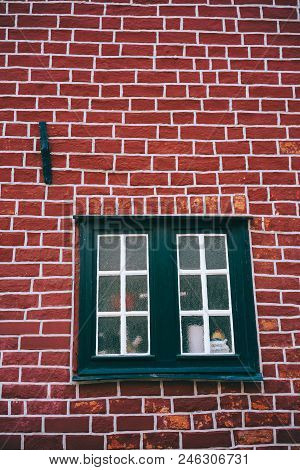 Traditional Medieval German Brick House In Luneburg, Germany. Fragment Of The Red Brick Facade With 