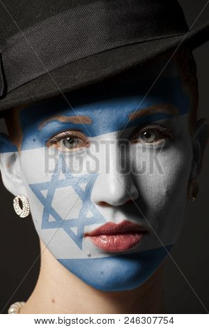 Woman Face With Painted Flag Of Israel Closeup
