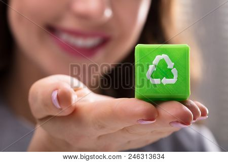 Woman Holding Cubic Block With Recycle Symbol