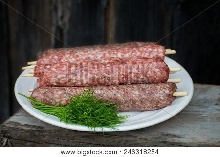 Raw Lulya Kebab From Meat On A White Plate.