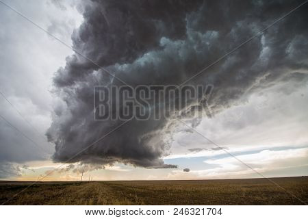 A Supercell Thunderstorm Towers Over The Landscape Of The Great Plains.