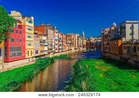 Colorful Red, Orange And Yellow Houses And Bridge Through River Onyar In Girona, Catalonia, Spain. S