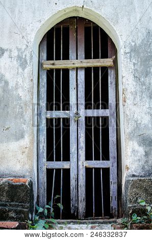 Old Wooden And Steel Grill Ancient Door Of Wat Phra Mahathat Lopburi.