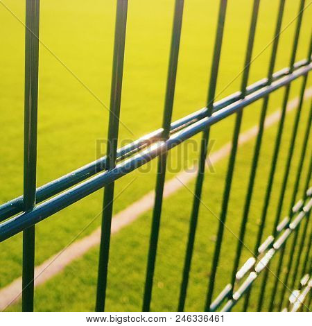 Lawn Field For Playing Minifootball Behind The Fence Mesh
