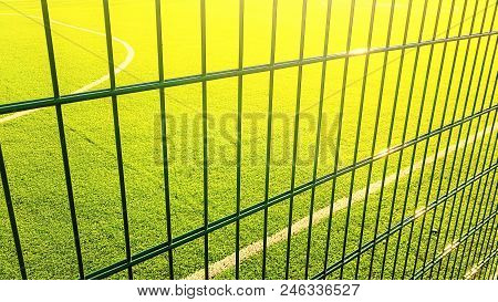 Lawn Field For Playing Minifootball Behind The Fence Mesh