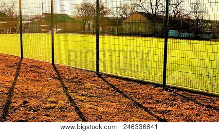 Lawn Field For Playing Minifootball Behind The Green Fence Mesh