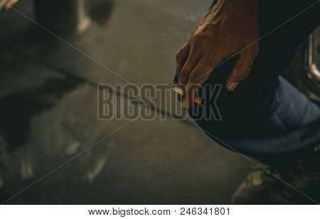 Asian Man With Dirty Hand Hold Cigarette And Smoke. Poor Asian Men Labor Sit And Smoking Cigarette W