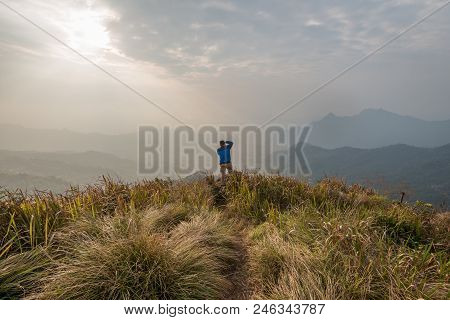 View Of A Man Take A Photo At The Top Of Phu Chi Fa In Chiang Rai, Thailand.