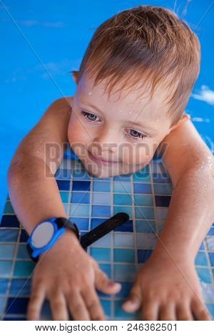 Smiling Baby Boy In Swimming Pool. Vertical